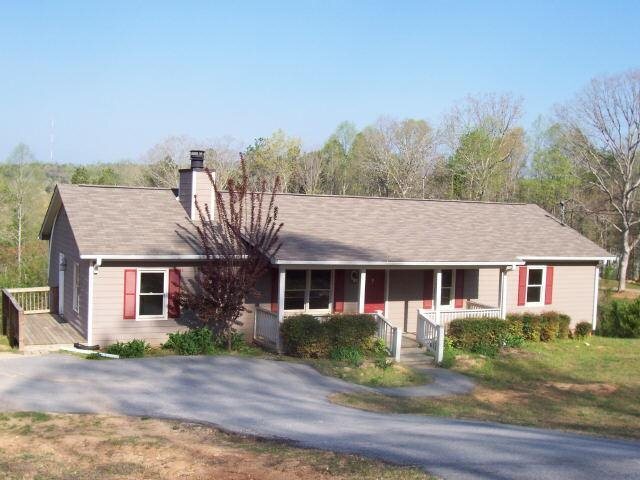 1303 Heads Ferry Road Cornelia, GA 30531 - Photo 1 of 1 a front view of a house with a yard