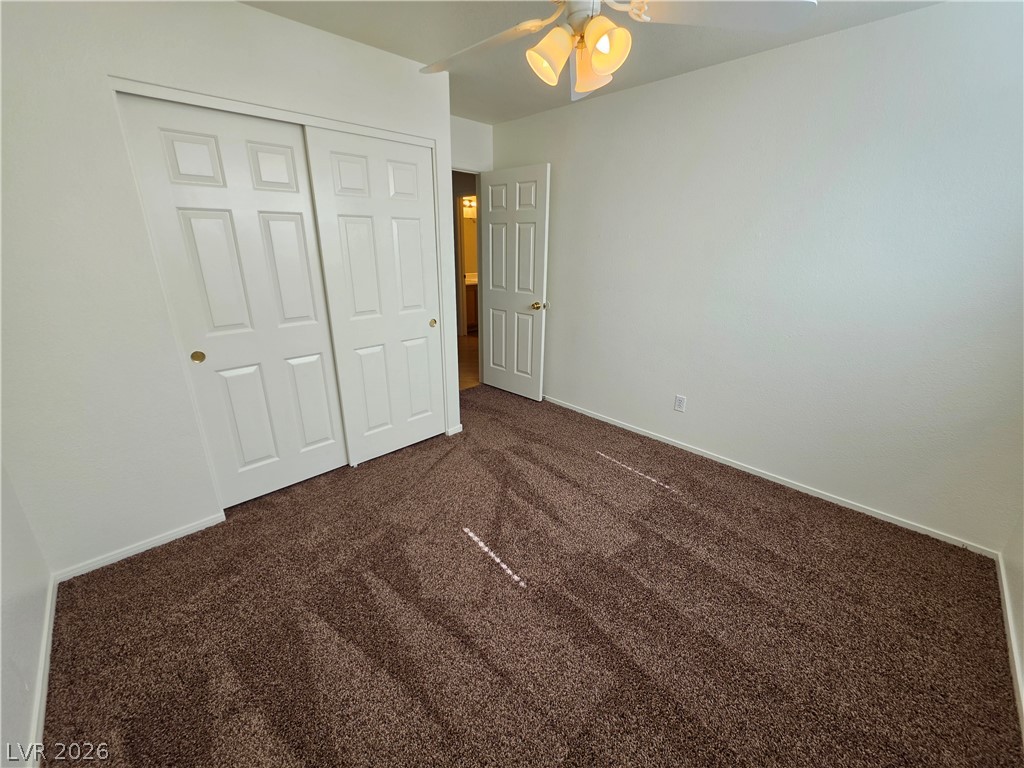 1154 Point Success Avenue Henderson, NV 89014 - Photo 16 of 26 Well-lit and ready for personalization, this bedroom offers ample space and plush carpeting.