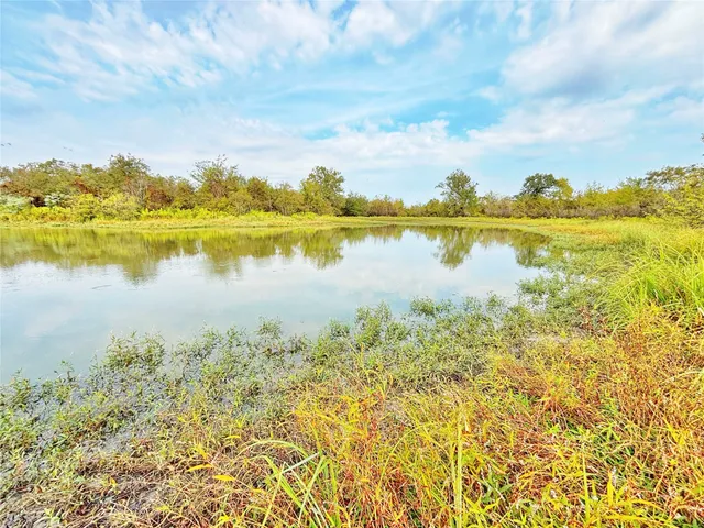 a view of a lake with a table and chairs