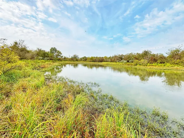 a view of a lake with houses in the back