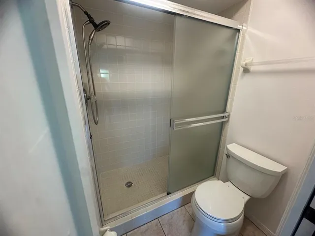 a bathroom with a shower and a toilet