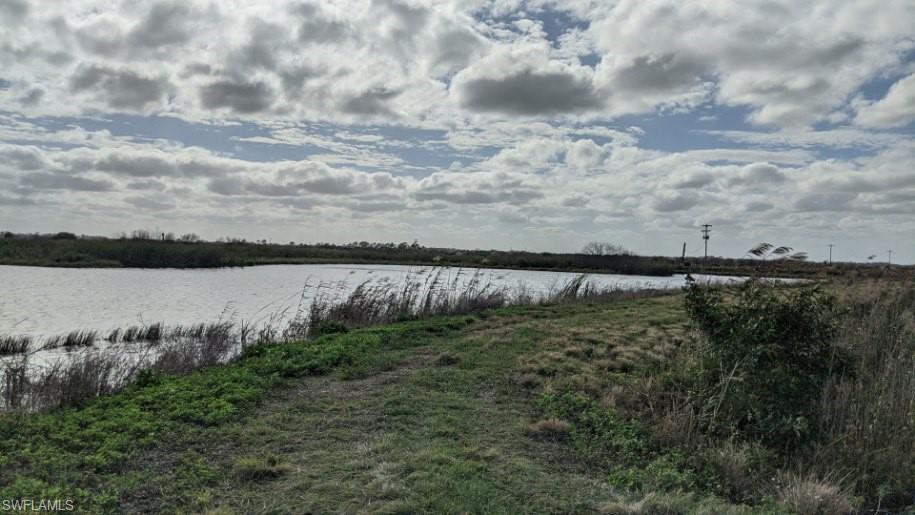 Xx Sears Road LaBelle, FL 33935 - Photo 2 of 4 a view of a lake from a yard