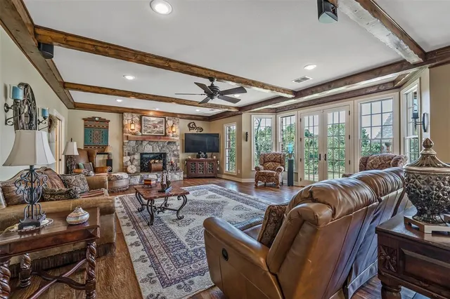 a living room with furniture and large windows