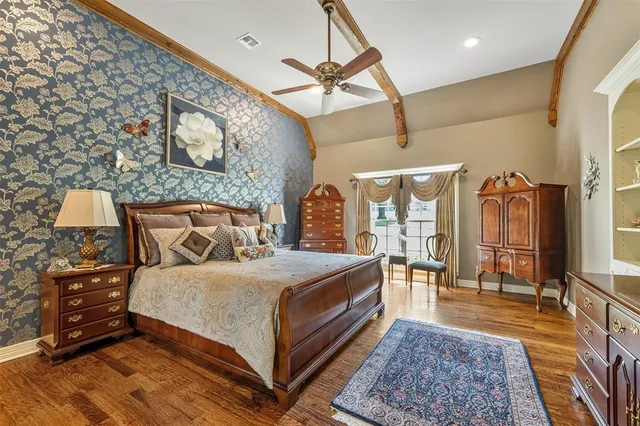 a bedroom with a bed a mirror and a desk