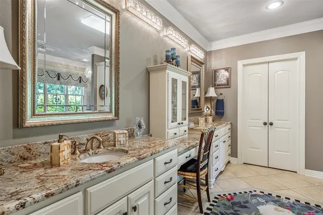 a bathroom with granite countertop a sink and a mirror