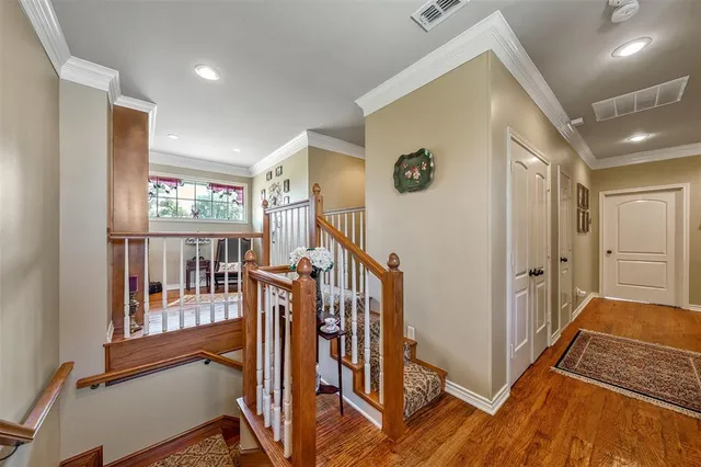 a view of a hallway with wooden floor and windows