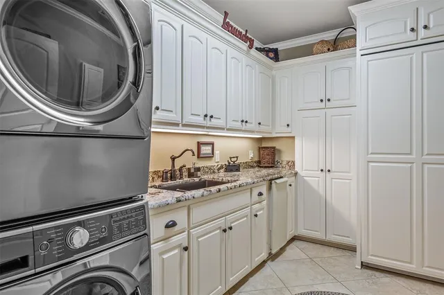 a utility room with sink dryer and washer