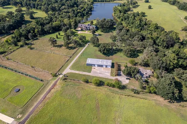 an aerial view of a residential houses with a swimming pool