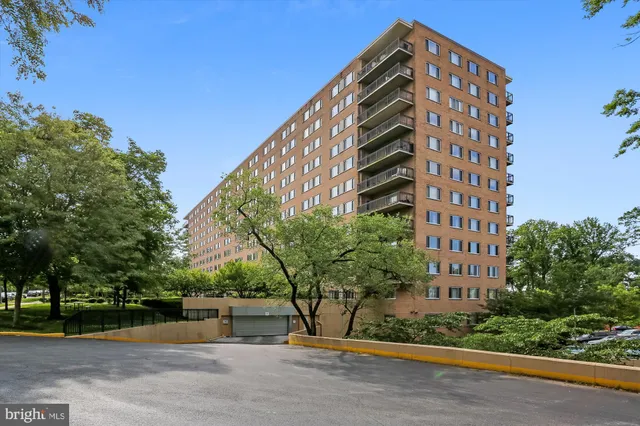 a view of a tall building next to a road