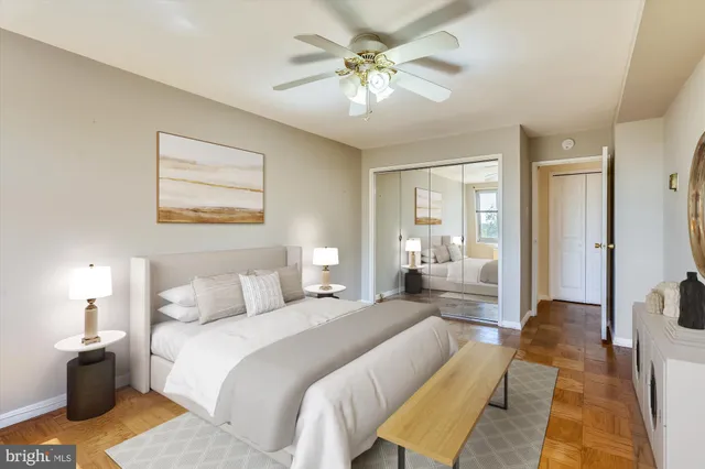 a spacious bedroom with a bed and a chandelier