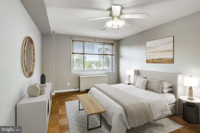 a bedroom with a bed mirror and window