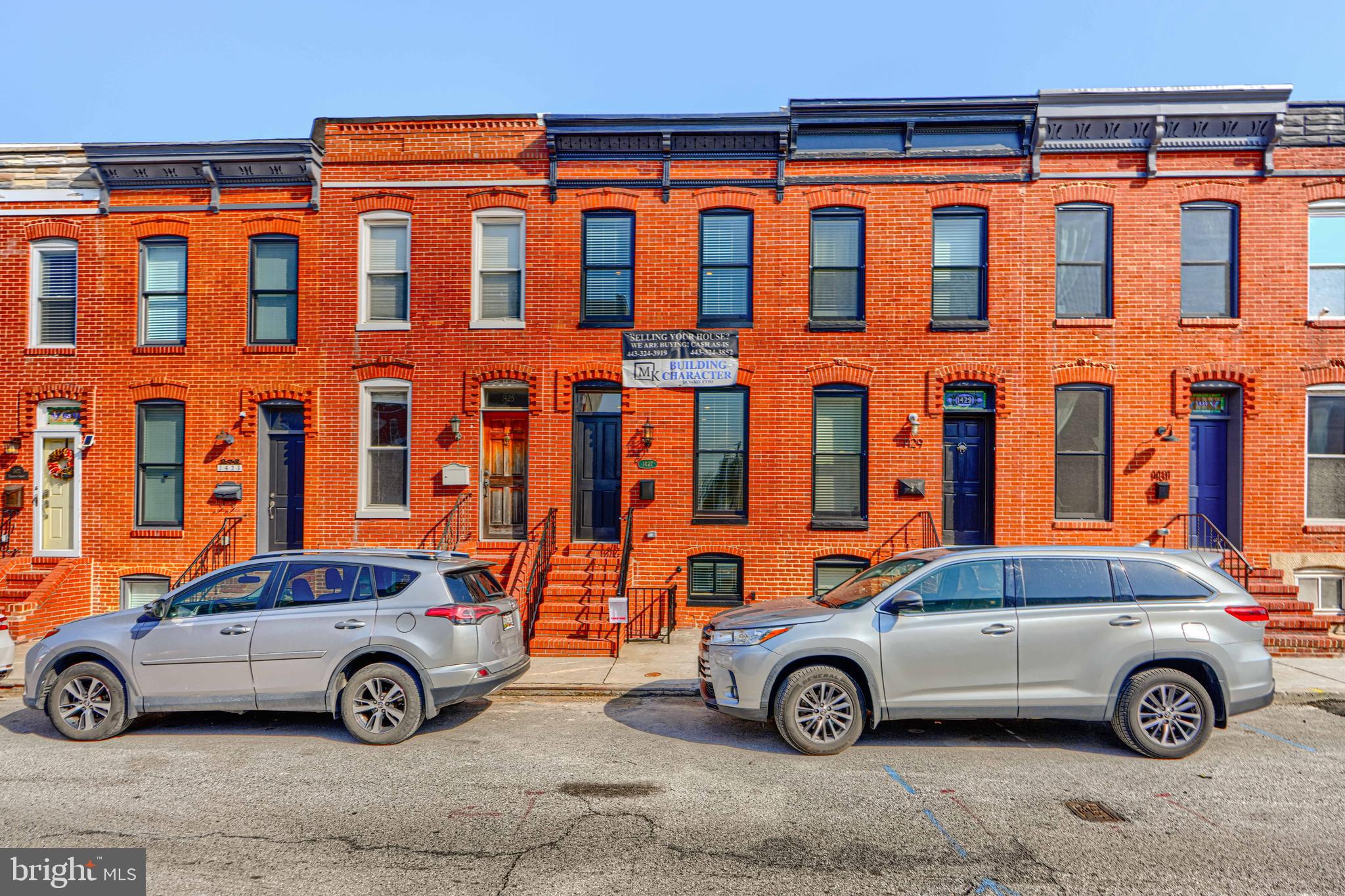 1427 Patapsco Street Baltimore, MD 21230 - Photo 1 of 34 a front view of a house with parking space