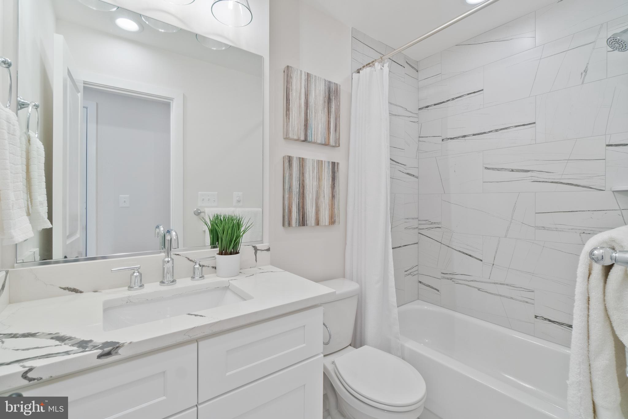 1427 Patapsco Street Baltimore, MD 21230 - Photo 14 of 20 a bathroom with a granite countertop sink toilet and shower