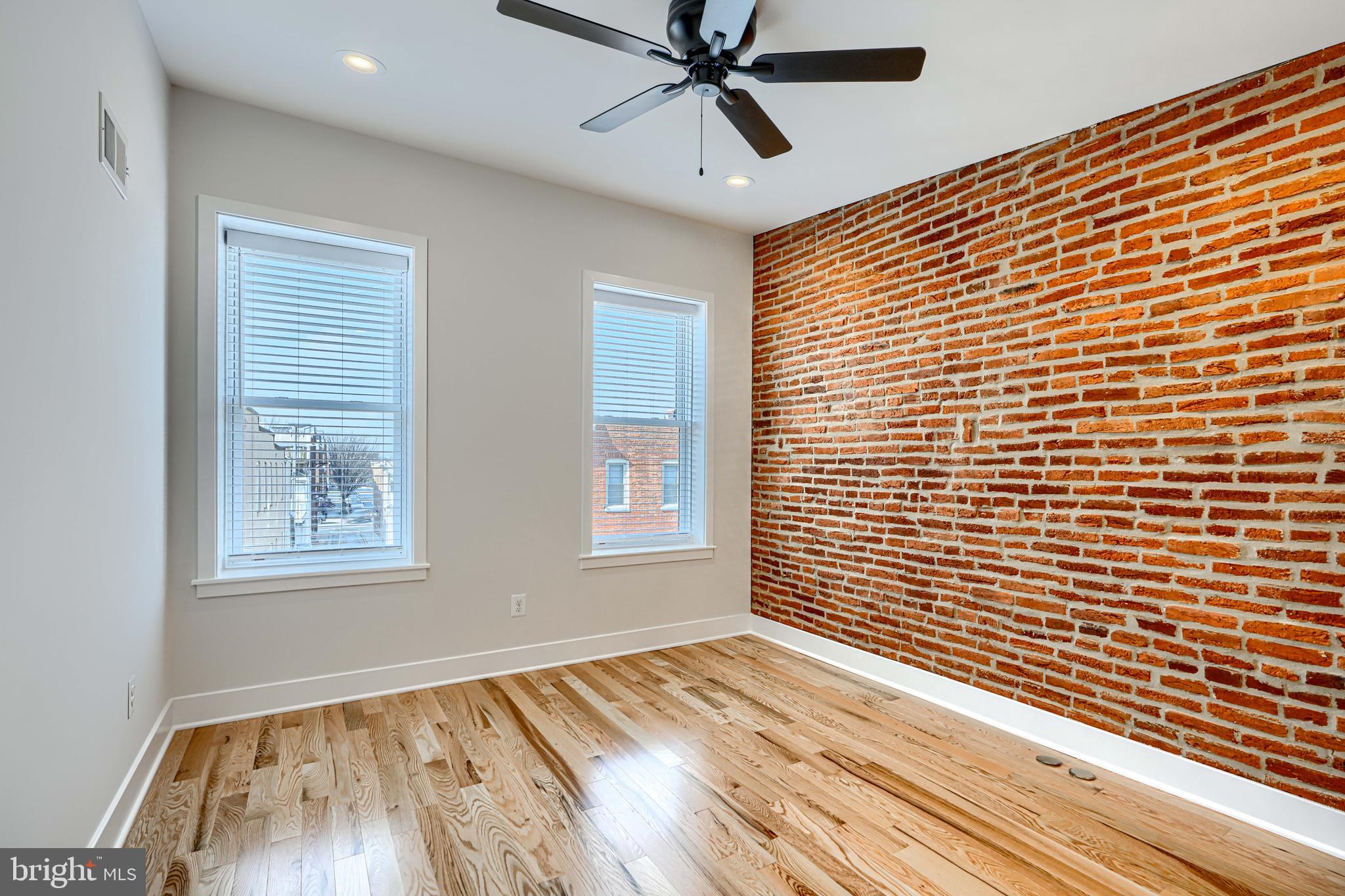 1427 Patapsco Street Baltimore, MD 21230 - Photo 19 of 34 a view of an empty room with wooden floor and a window