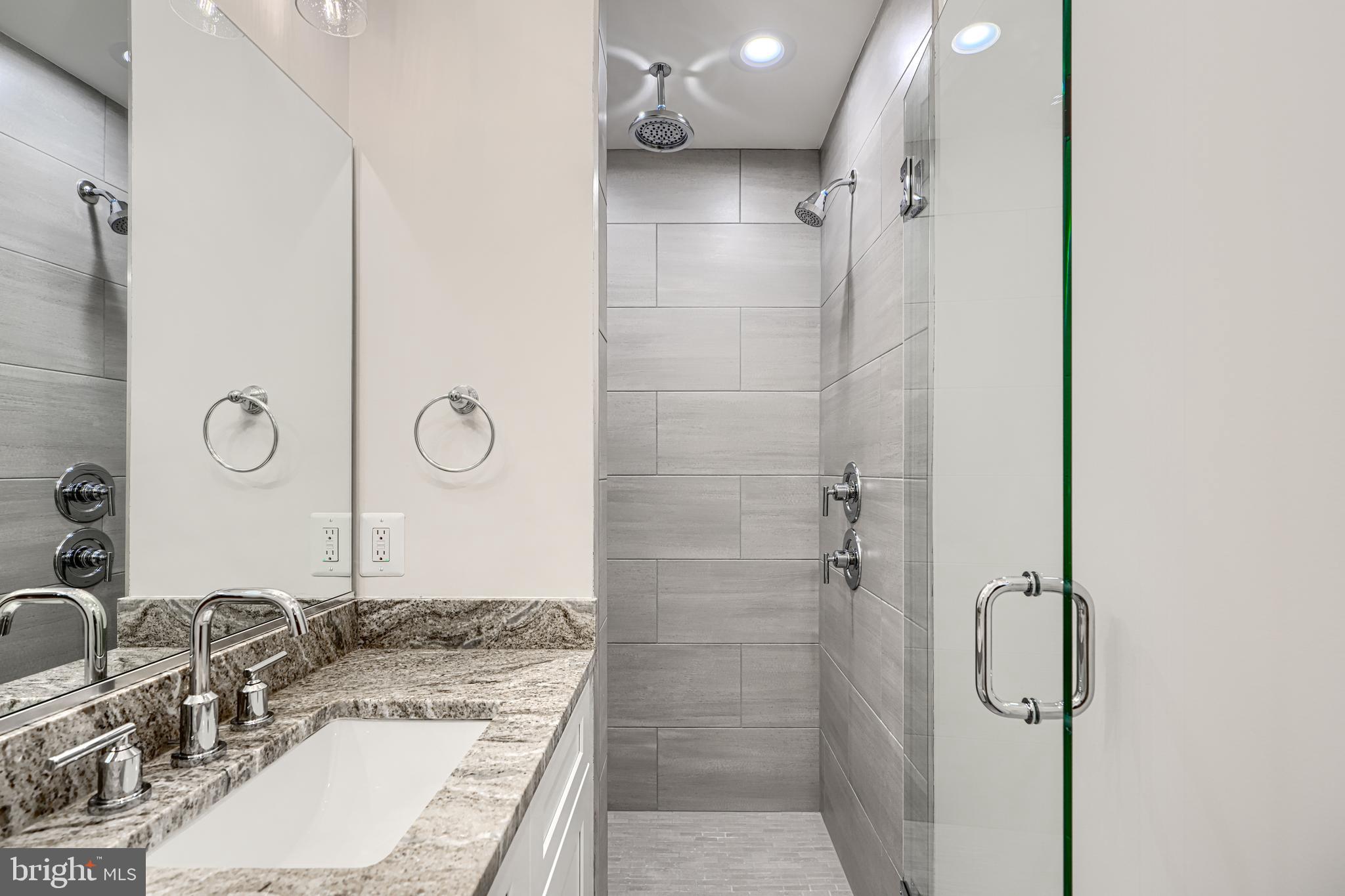 1427 Patapsco Street Baltimore, MD 21230 - Photo 22 of 34 a bathroom with a granite countertop sink mirror and shower