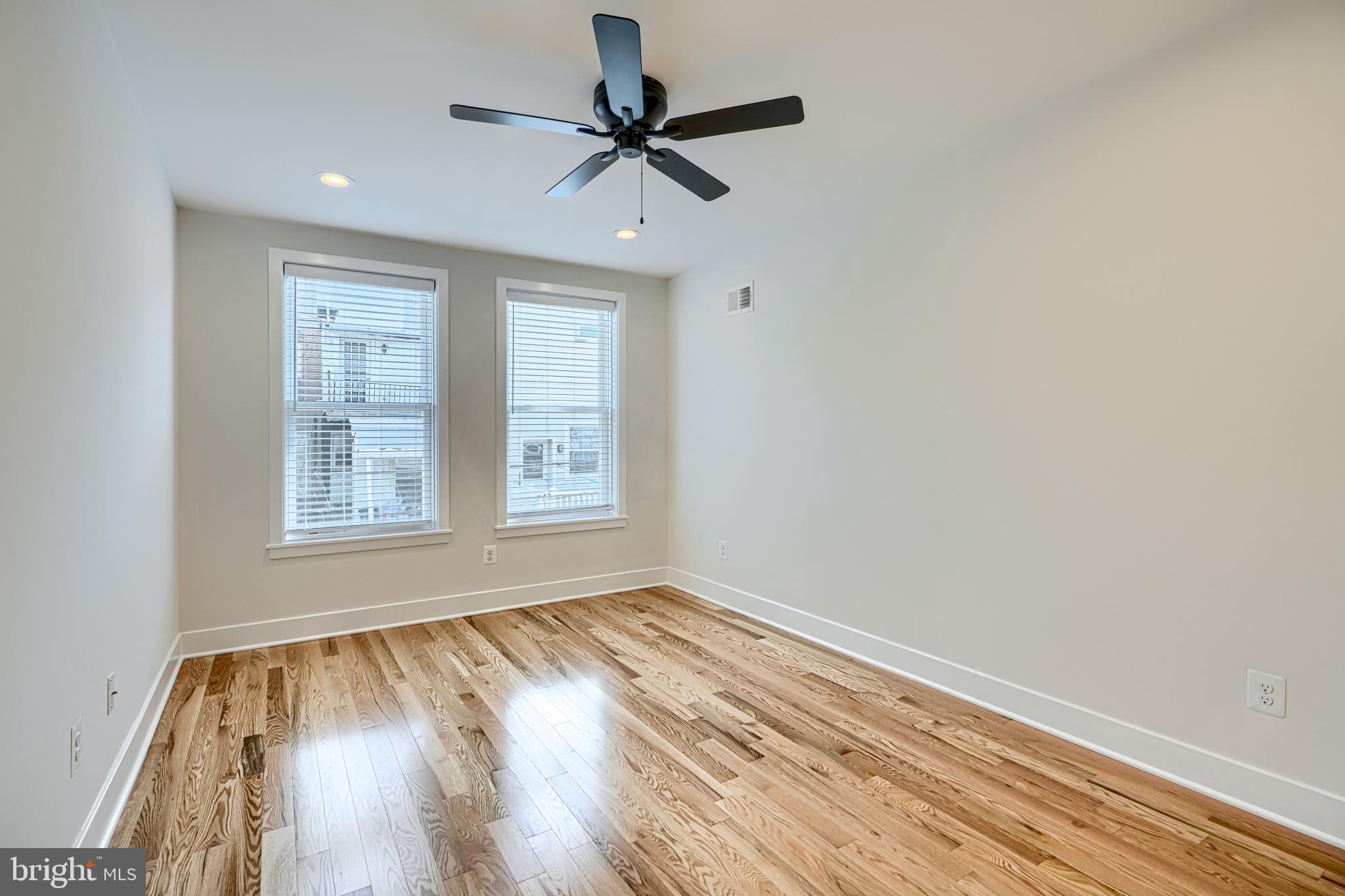 1427 Patapsco Street Baltimore, MD 21230 - Photo 23 of 34 a view of empty room with wooden floor and fan