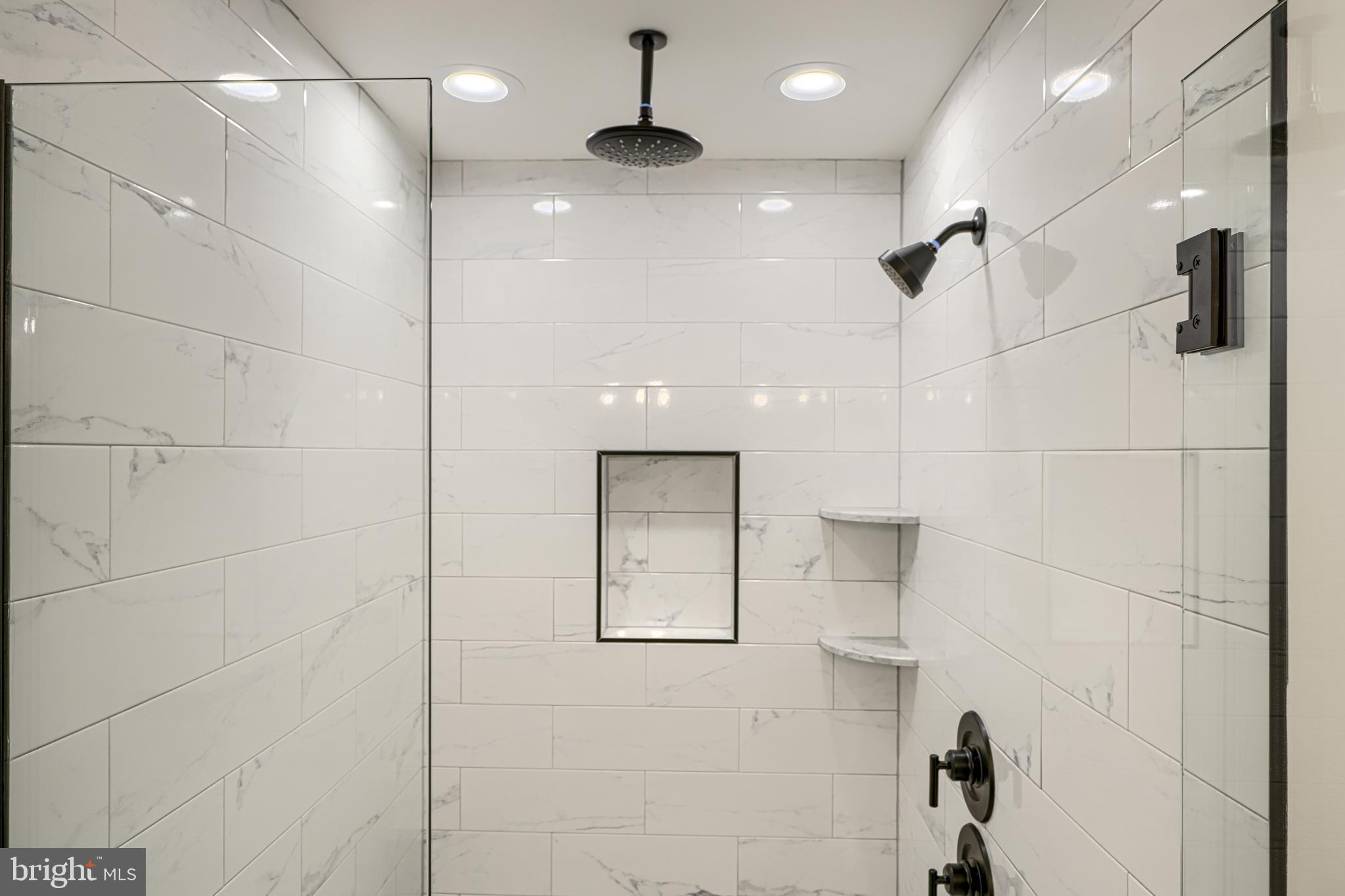 1427 Patapsco Street Baltimore, MD 21230 - Photo 29 of 34 a bathroom with a glass shower door and a shower