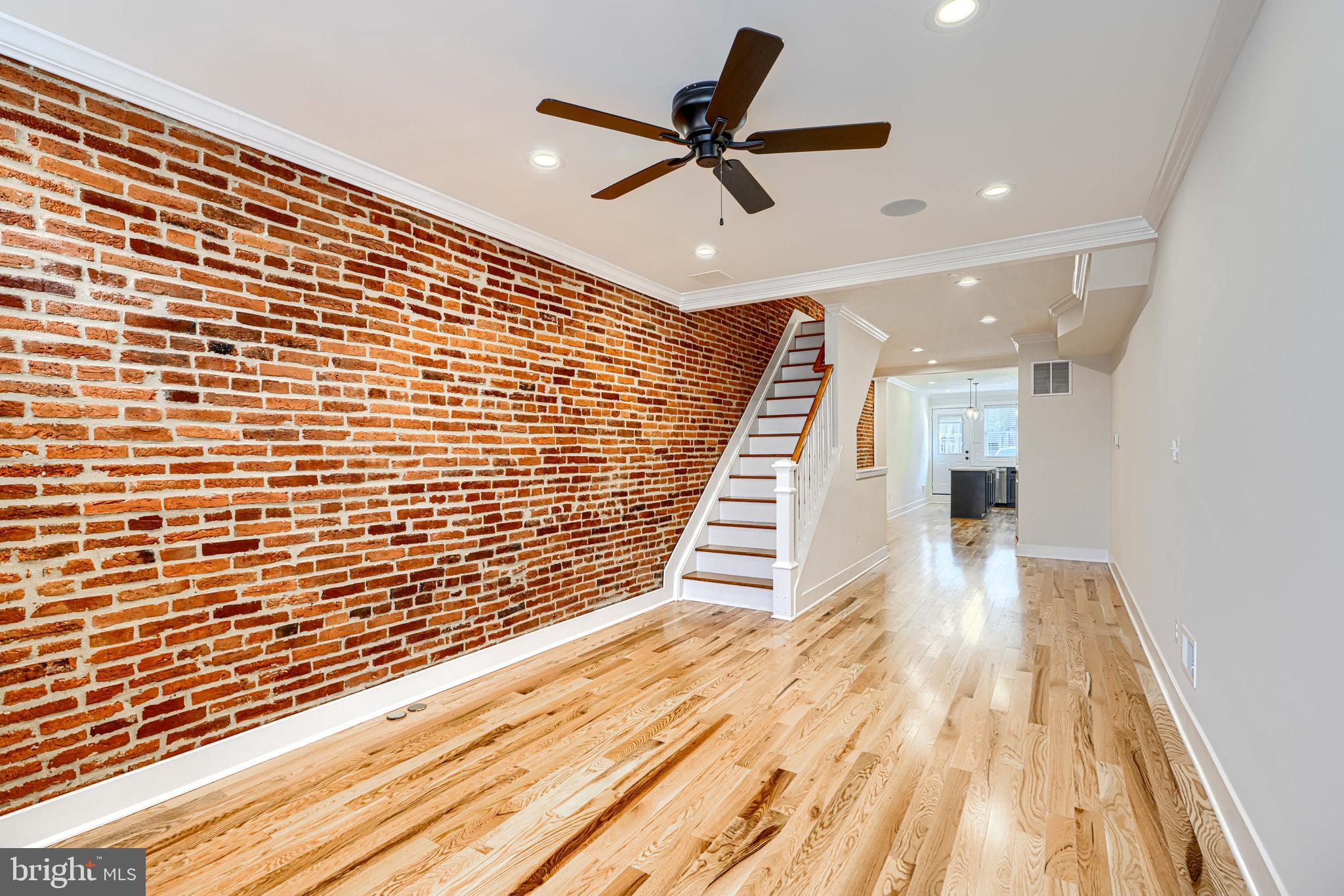 1427 Patapsco Street Baltimore, MD 21230 - Photo 3 of 34 a view of room with stairs and wooden floor