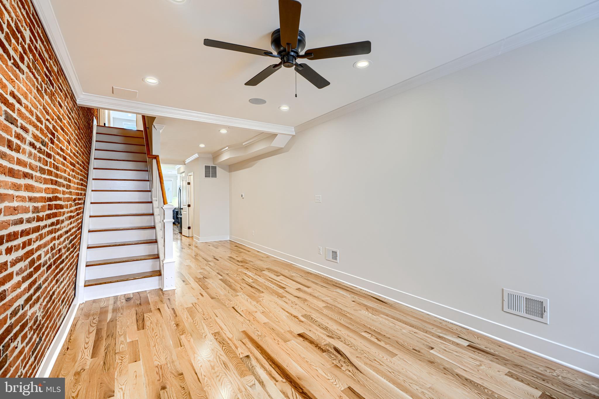 1427 Patapsco Street Baltimore, MD 21230 - Photo 4 of 34 a view of a room with wooden floor and white walls