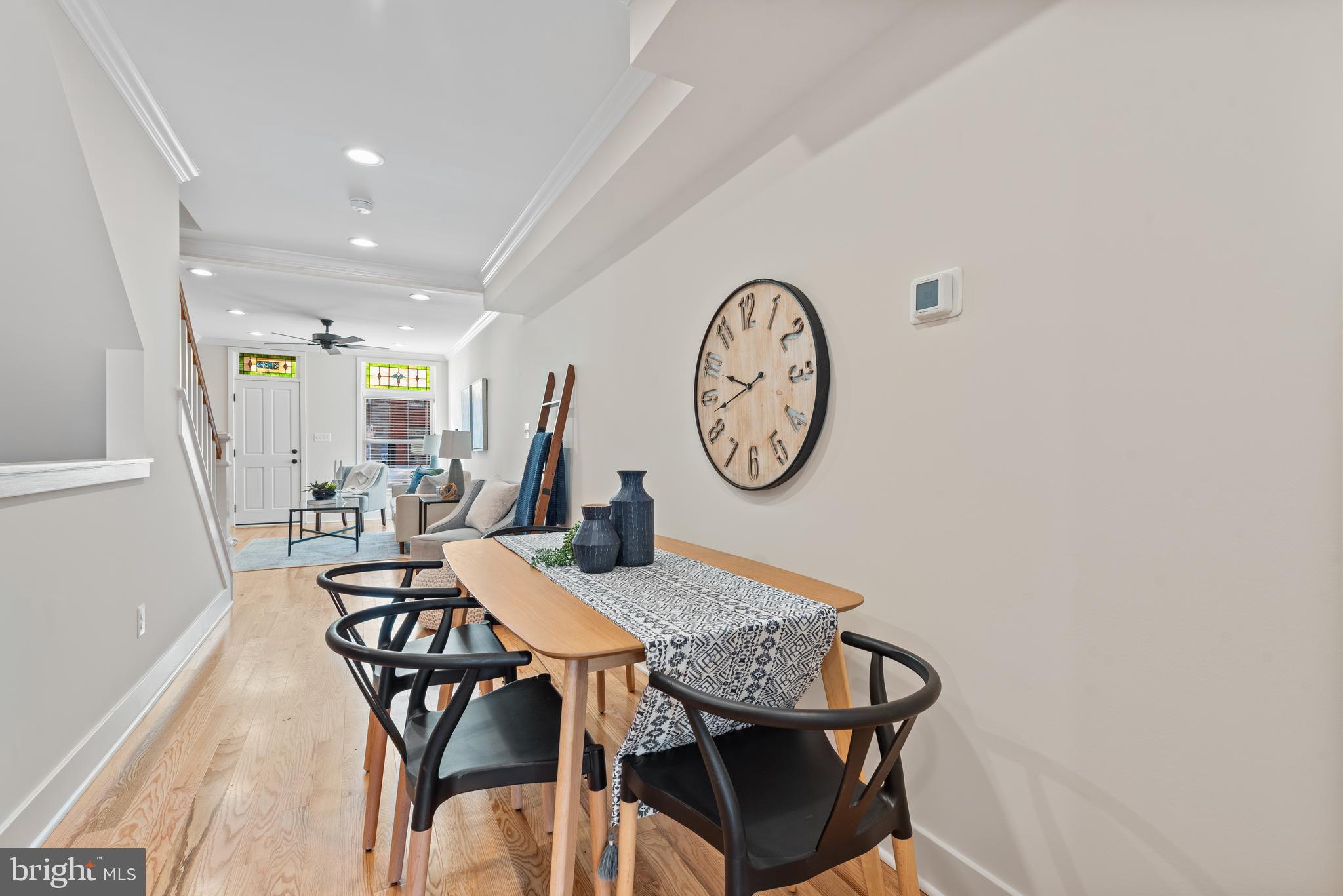 1427 Patapsco Street Baltimore, MD 21230 - Photo 5 of 20 a view of a dining area with furniture and a clock