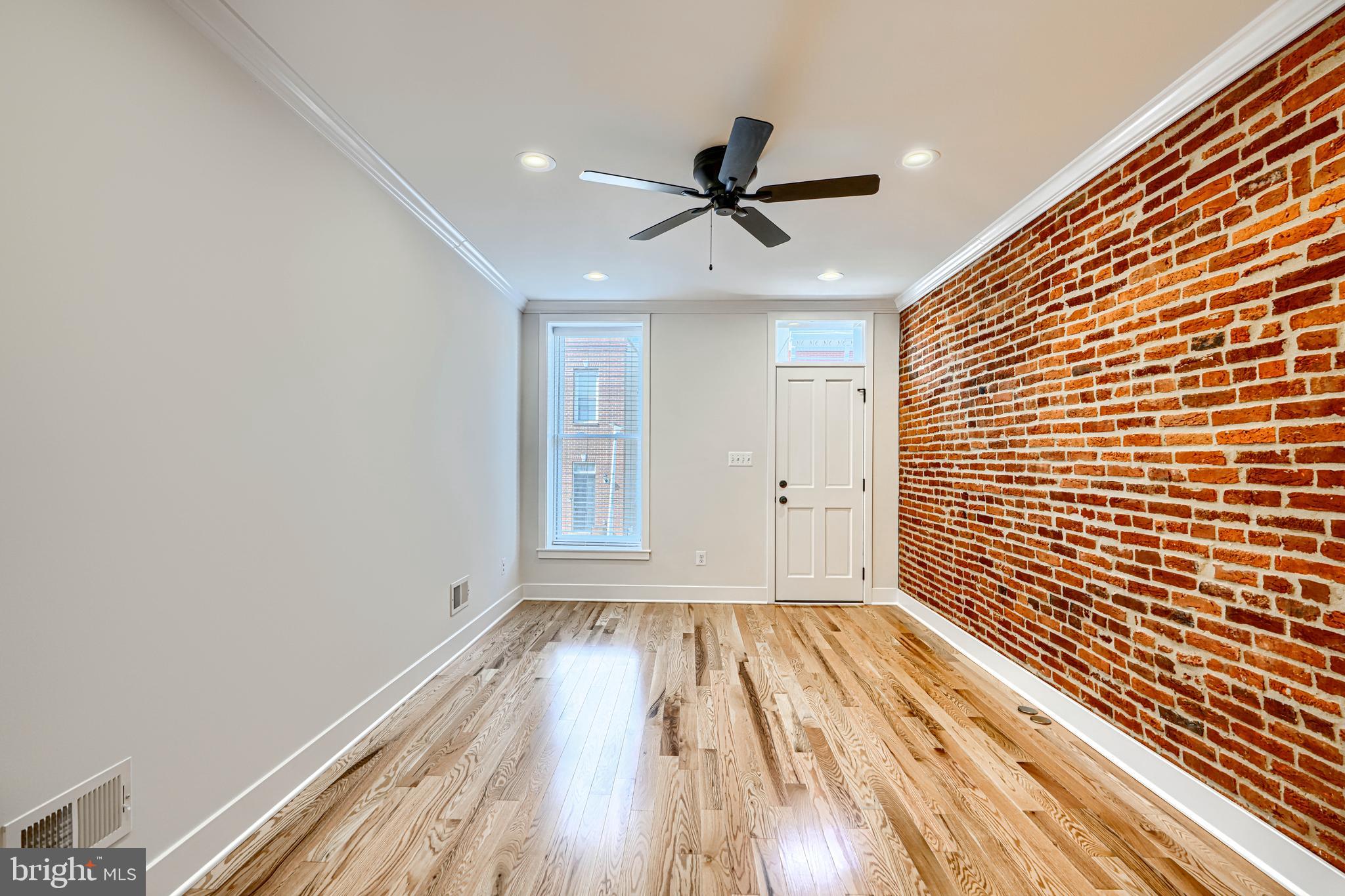 1427 Patapsco Street Baltimore, MD 21230 - Photo 5 of 34 a view of empty room with wooden floor and fan