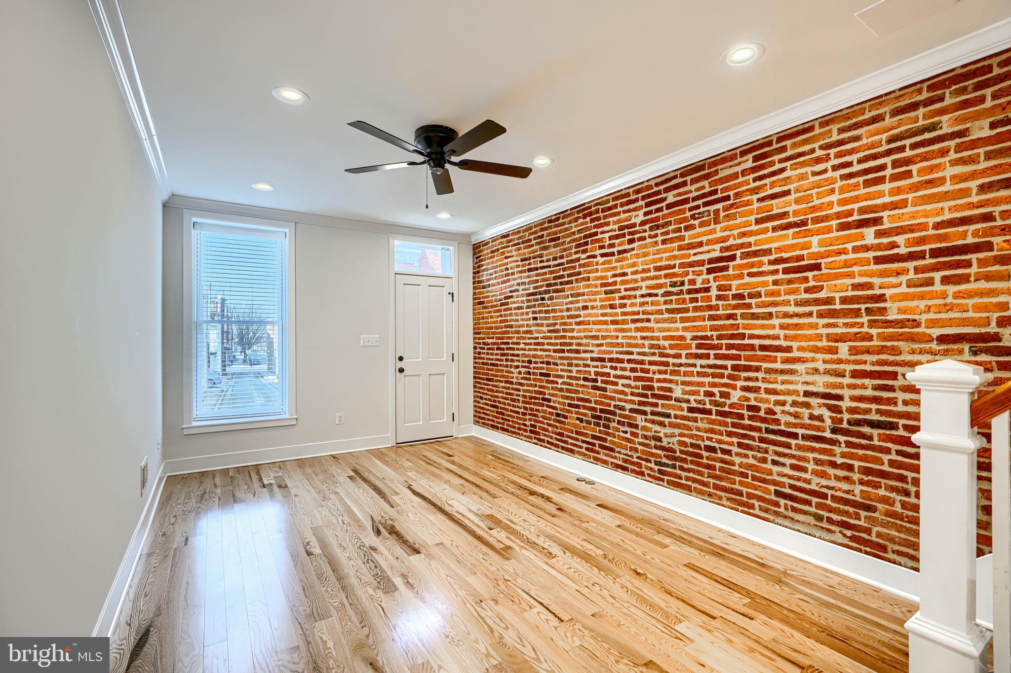 1427 Patapsco Street Baltimore, MD 21230 - Photo 6 of 34 a view of empty room with wooden floor and fan