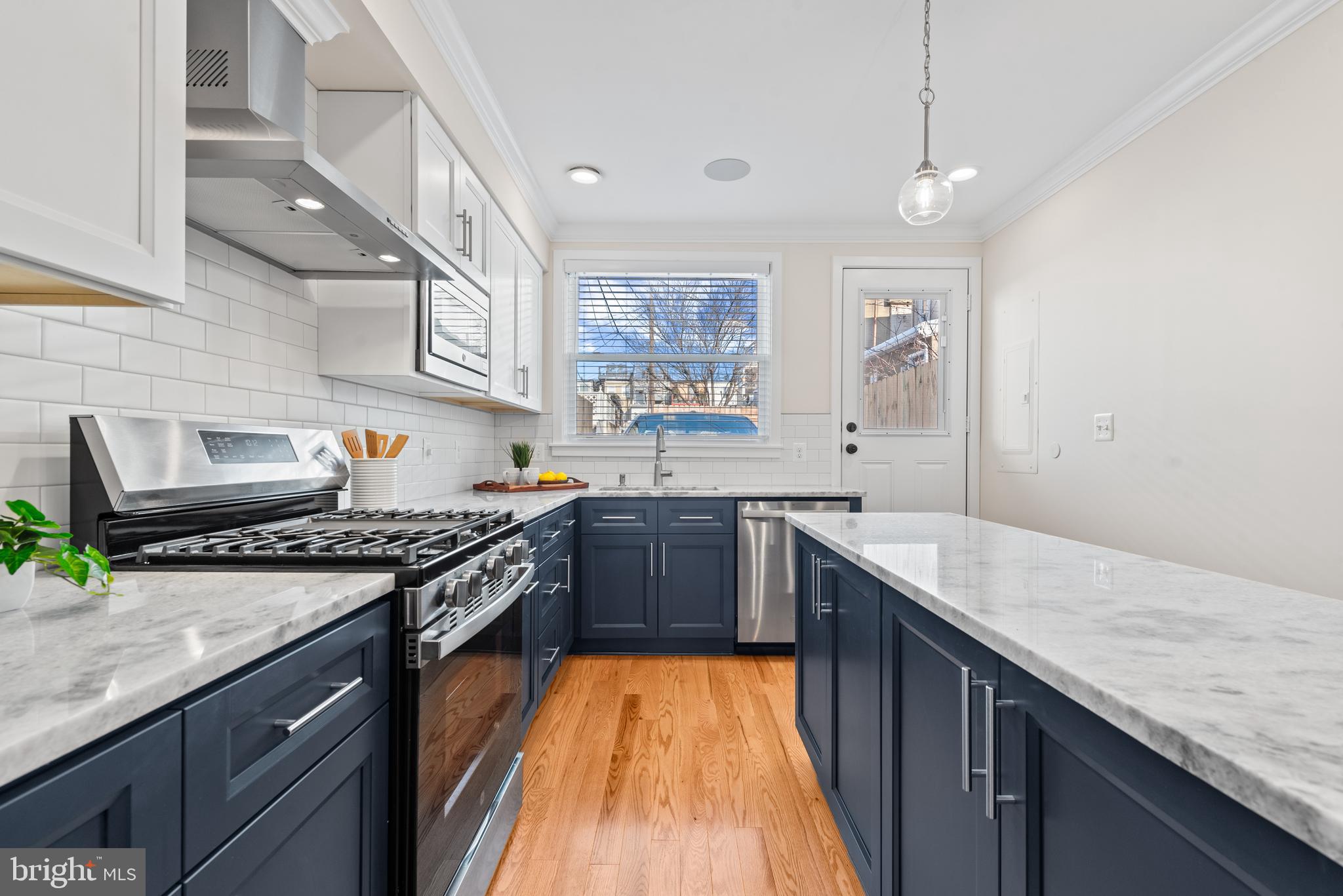 1427 Patapsco Street Baltimore, MD 21230 - Photo 9 of 20 a kitchen with granite countertop stainless steel appliances and wooden cabinets