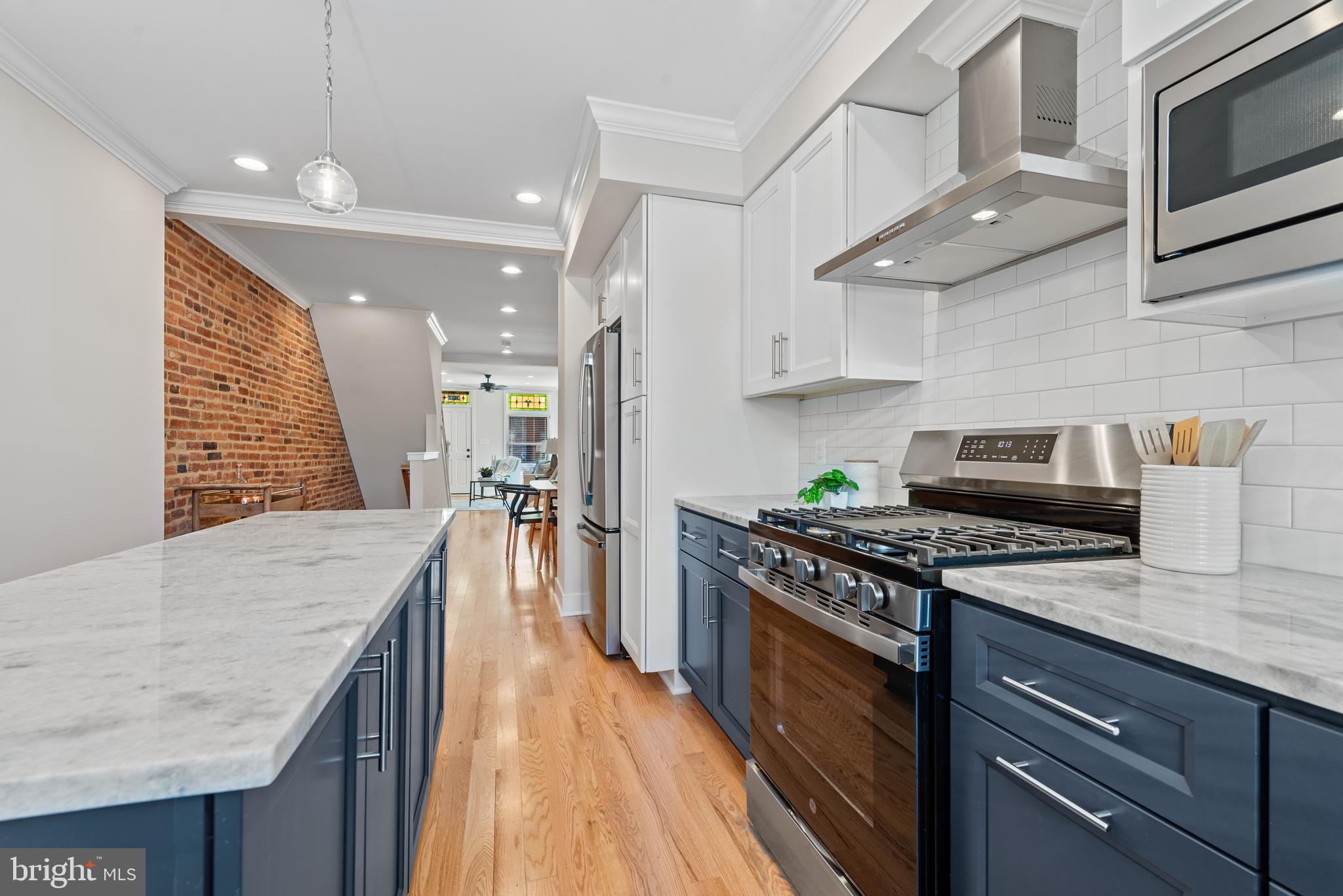 1427 Patapsco Street Baltimore, MD 21230 - Photo 10 of 20 a kitchen with stainless steel appliances granite countertop sink stove top oven and cabinets