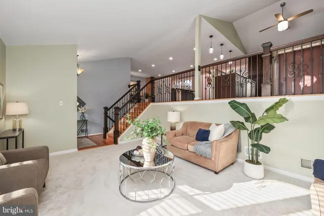 a view of a hallway with wooden floor and stairs