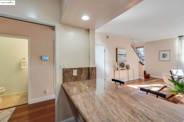 a kitchen with stainless steel appliances granite countertop a sink and a refrigerator