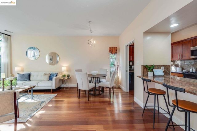 a living room with dining room and wooden floor