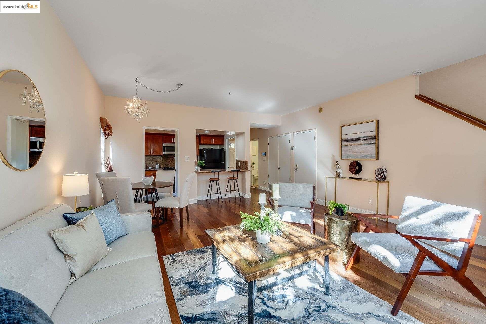 2316 Blake Street, Unit D Berkeley, CA 94704 - Photo 20 of 31 Living room featuring wood finished floors and a chandelier
