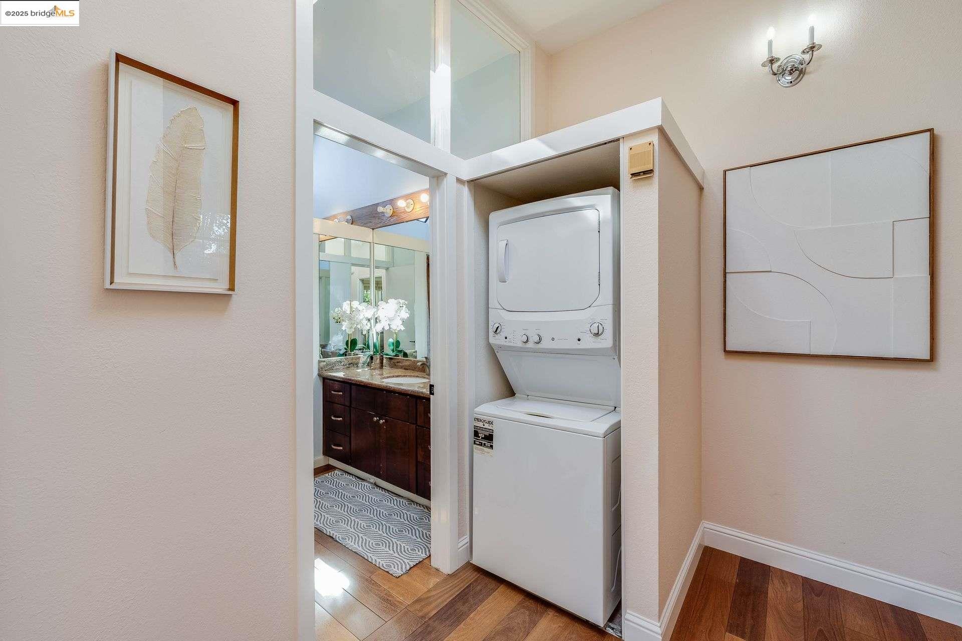 2316 Blake Street, Unit D Berkeley, CA 94704 - Photo 22 of 31 Washroom with light wood-style flooring and stacked washer / dryer