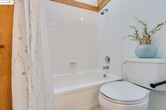 a bathroom with a granite countertop sink mirror and shower