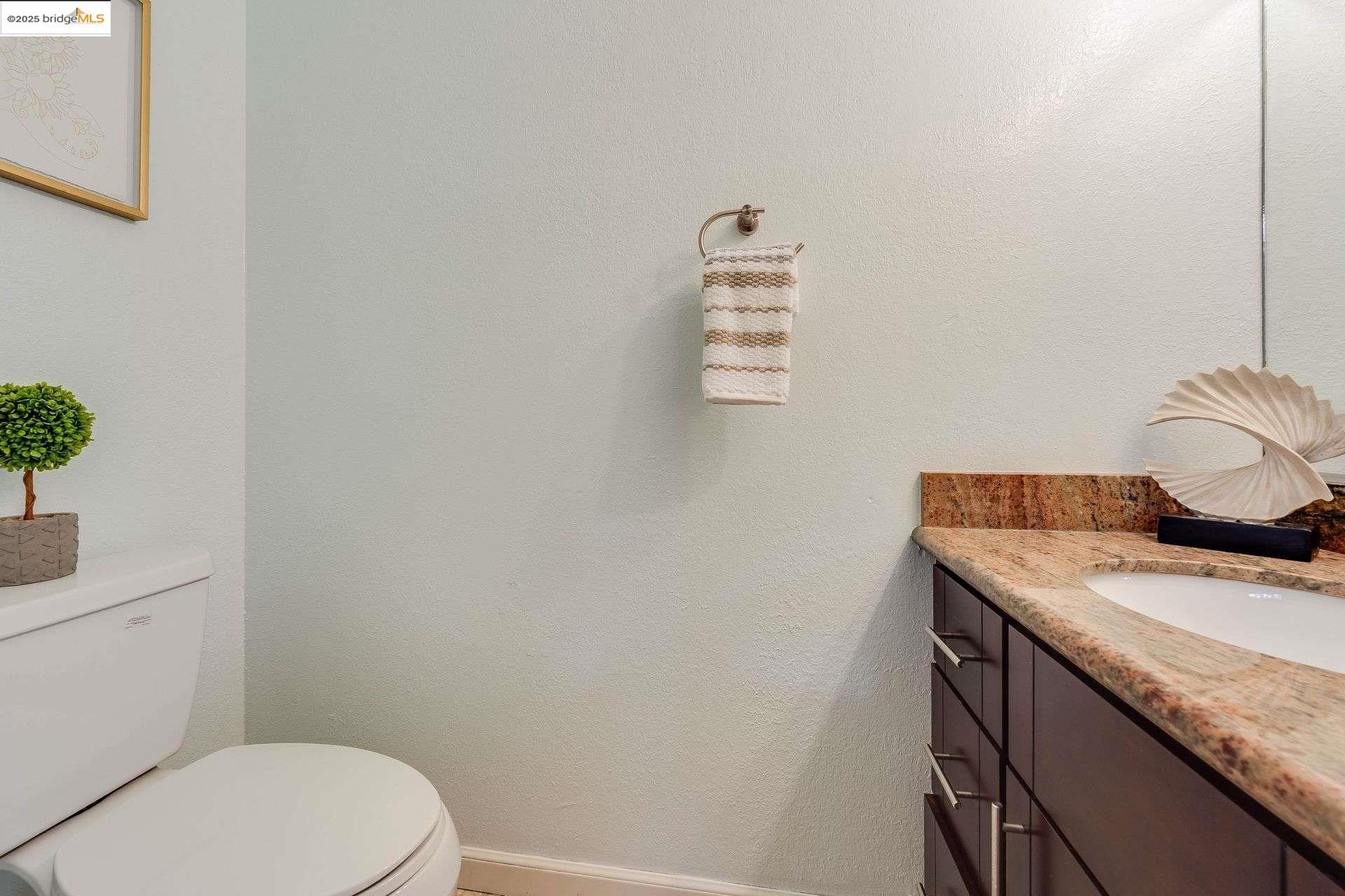 2316 Blake Street, Unit D Berkeley, CA 94704 - Photo 8 of 31 Half bath with a textured wall and vanity
