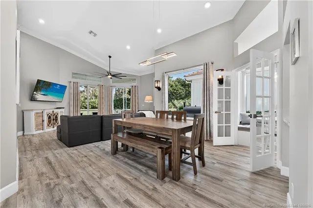 a living room with furniture a dining table and a wooden floor