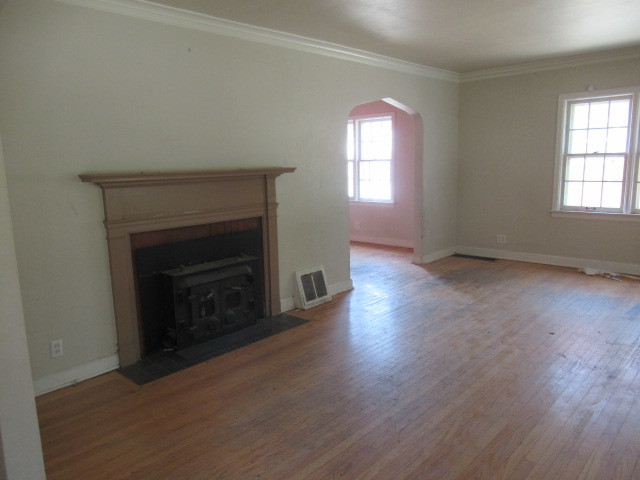 505 South Prospect Avenue Champaign, IL 61820 - Photo 5 of 19 an empty room with wooden floor fireplace and windows