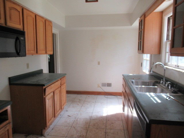 505 South Prospect Avenue Champaign, IL 61820 - Photo 9 of 19 a kitchen with stainless steel appliances granite countertop a sink a stove and a microwave