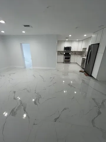 a view of kitchen with cabinets and wooden floor