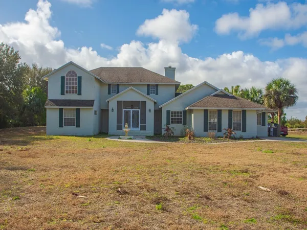 a front view of a house with yard