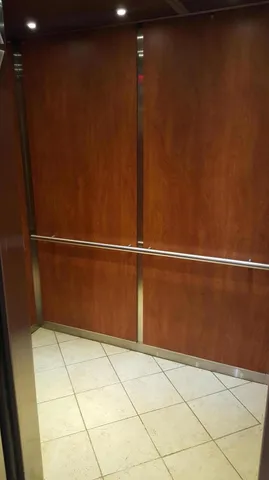 an empty room with closet and mirror