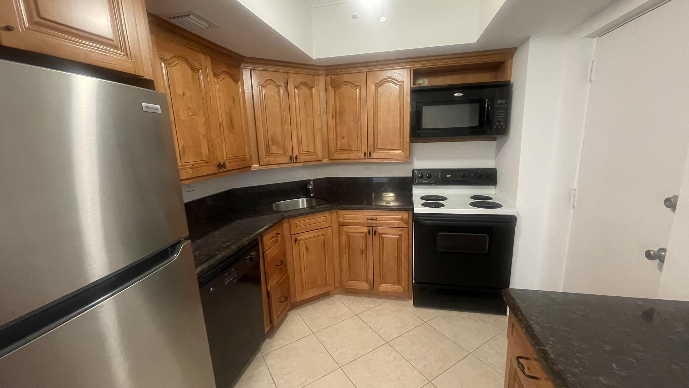 50 Southwest 3rd Avenue, Unit 2010 Boca Raton, FL 33432 - Photo 13 of 22 a kitchen with a refrigerator and a stove