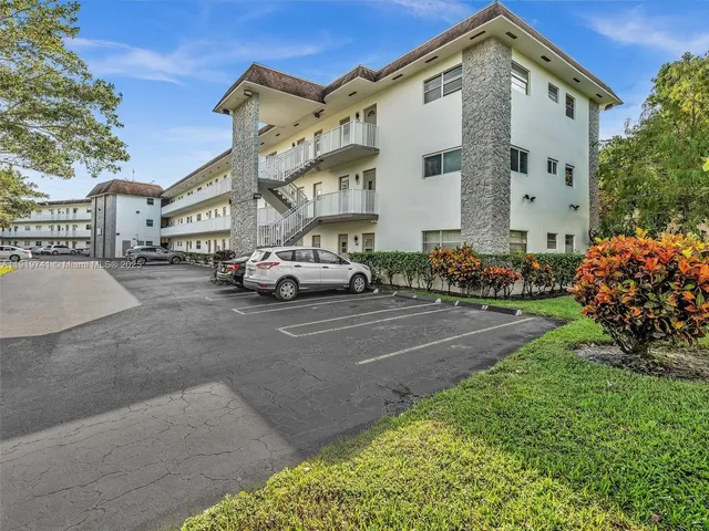 a city street lined with buildings and cars parked in front of it