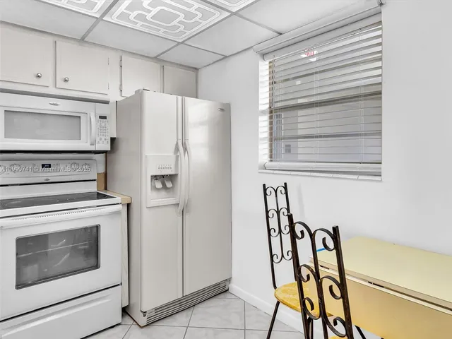 a kitchen with stainless steel appliances a stove a refrigerator and island