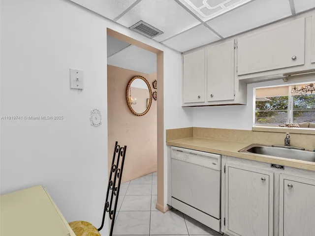a kitchen with a sink a stove and cabinets
