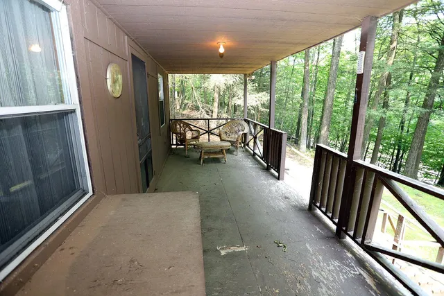 a view of hallway with furniture and a large window