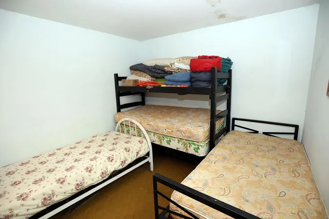 a bedroom with bed and a window