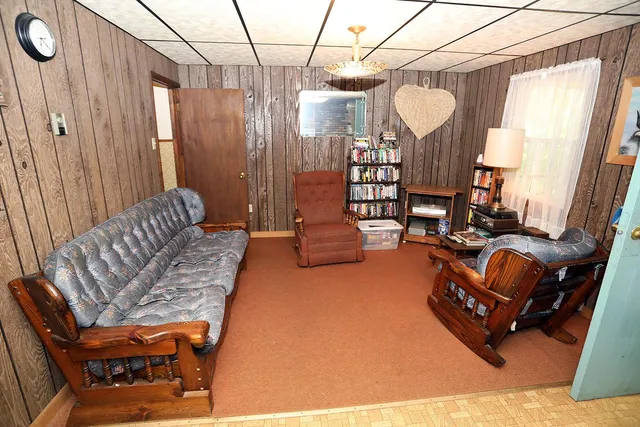 a living room with furniture a couch and chandelier