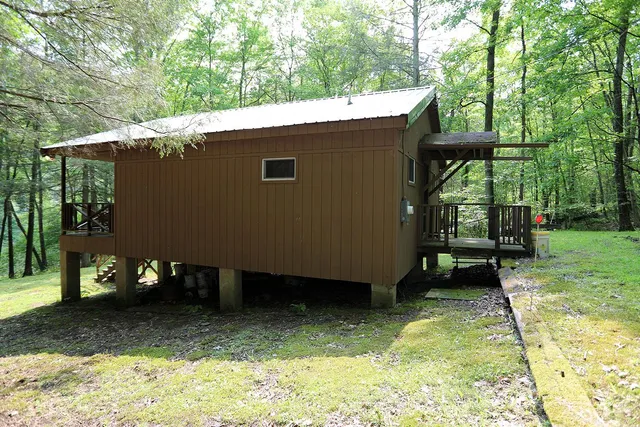 a backyard of a house with table and chairs