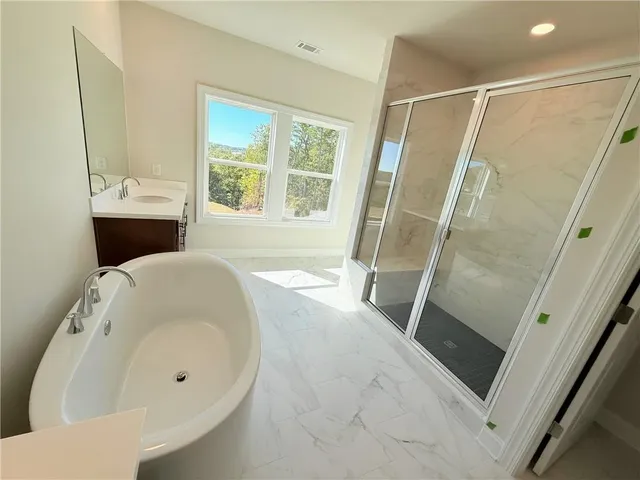 a bathroom with a shower and a sink